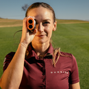 Female golfer holding A1-Slope Laser Rangefinder.